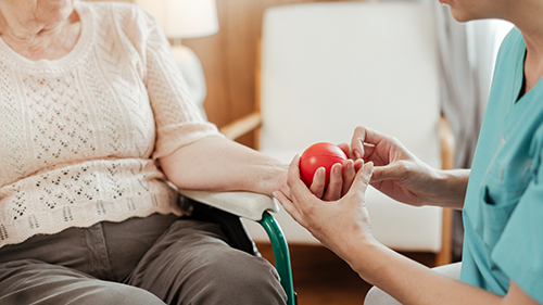 BlogPost4 Parkinsons nursing care with a patient practicing hand mobility 500px
