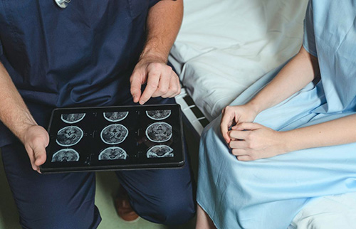 Nurse Showing Patient Brain Scans